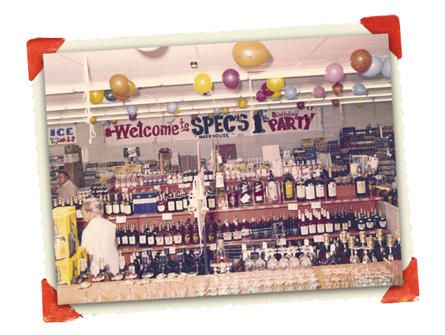 Vintage photograph of store decorated with balloons for Spec's 1st birthday party